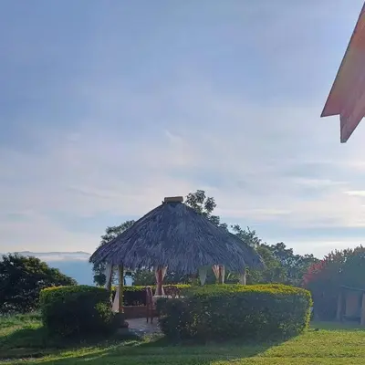 a hut with a table and chairs in the grass at Camping San Gabriel in Angostura