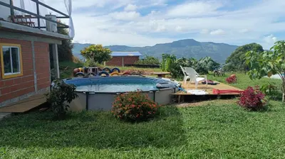 a swimming pool in the yard of a house at Camping San Gabriel in Angostura