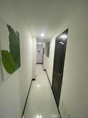 a hallway with a black door in a room at Apartamento Cozy in Medellín