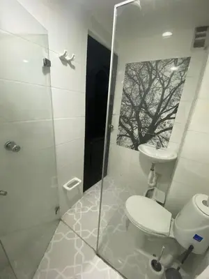 a bathroom with a toilet and a sink and a shower at Apartamento Cozy in Medellín
