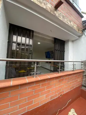 a balcony with a brick wall and a window at Apartamento Cozy in Medellín
