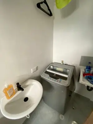 a bathroom with a sink and a trash can at Apartaestudio Calle 51, Avenida Santander in Manizales