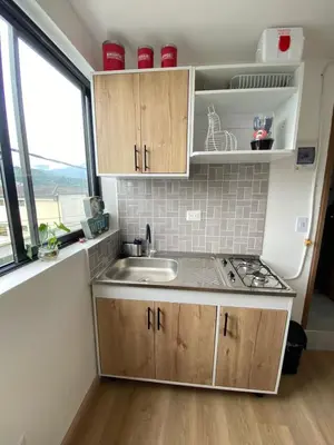 a small kitchen with a sink and a window at Apartaestudio Calle 51, Avenida Santander in Manizales