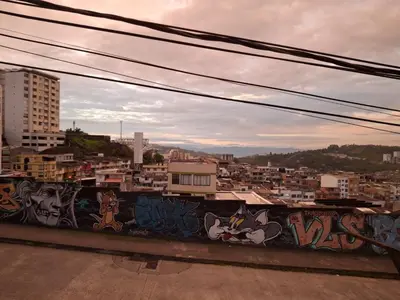 a view of a city with graffiti on a wall at Apartaestudio Calle 51, Avenida Santander in Manizales