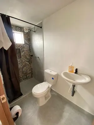 a bathroom with a toilet and a sink at Apartaestudio Calle 51, Avenida Santander in Manizales
