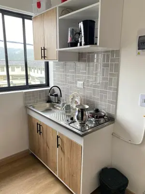a kitchen with a sink and a stove at Apartaestudio Calle 51, Avenida Santander in Manizales