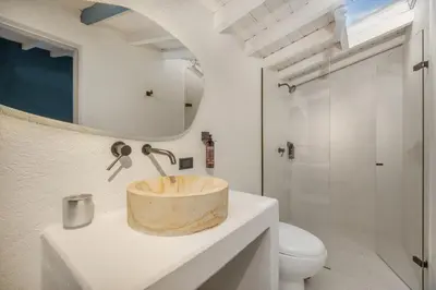 a bathroom with a sink and a toilet at Nago Hometel Boutique in Medellín