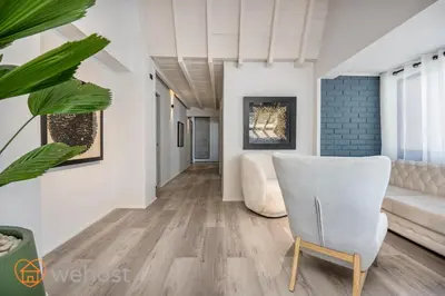 a living room with a couch and a chair at Nago Hometel Boutique in Medellín