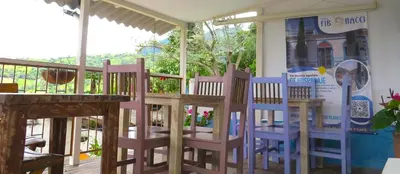 a group of chairs sitting on a porch at Casa Fibonacci in Titiribí