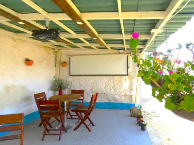 a room with a table and chairs and a whiteboard at Casa Fibonacci in Titiribí