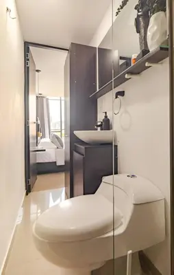 a bathroom with a toilet and a sink at Urbanlifestudios in Medellín
