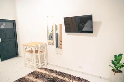 a room with a door and a mirror and a stool at Aparta estudio 205- Casa Bendita in Medellín