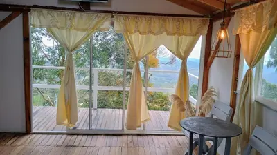 a large window with a table in front of it at Chalet Campestre San Gabriel in Angostura