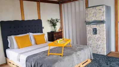 a bedroom with a bed with a yellow table on it at Chalet Campestre San Gabriel in Angostura