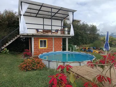 a house with a swimming pool in the yard at Chalet Campestre San Gabriel in Angostura
