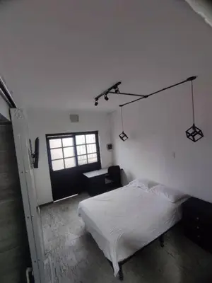 a bedroom with a white bed and a window at Espectacular Aparta estudio Laureles in Medellín