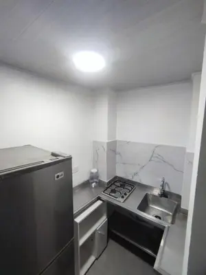 a kitchen with a stainless steel refrigerator and a sink at Espectacular Aparta estudio Laureles in Medellín