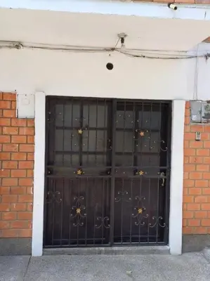 a pair of metal doors in a brick building at Espectacular Aparta estudio Laureles in Medellín