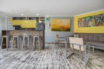 a living room with a bar and a couch at Apartamentos Ayamonte by HOUSY HOST in Medellín