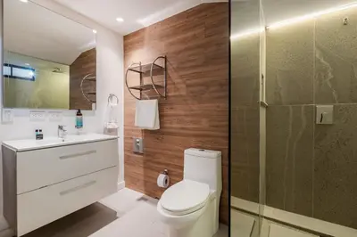a bathroom with a toilet and a glass shower at Apartamentos Ayamonte by HOUSY HOST in Medellín