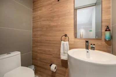 a bathroom with a white sink and a toilet at Apartamentos Ayamonte by HOUSY HOST in Medellín