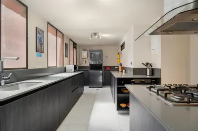 a kitchen with a sink and a stove at Apartamentos Ayamonte by HOUSY HOST in Medellín