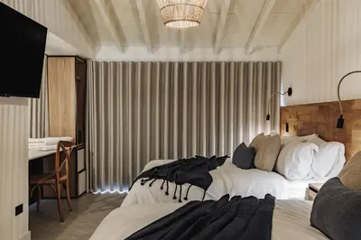a hotel room with two beds and a desk at 10A House Pool Provenza in Medellín