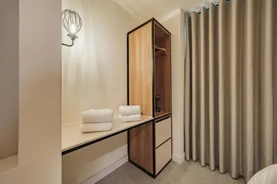 a bathroom with a mirror and towels on a counter at 10A House Pool Provenza in Medellín