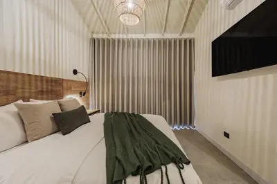 a bedroom with a bed and a television in it at 10A House Pool Provenza in Medellín