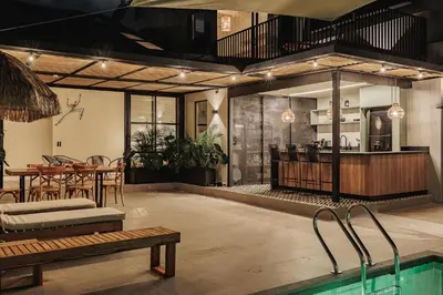a room with a pool and a table and a kitchen at 10A House Pool Provenza in Medellín