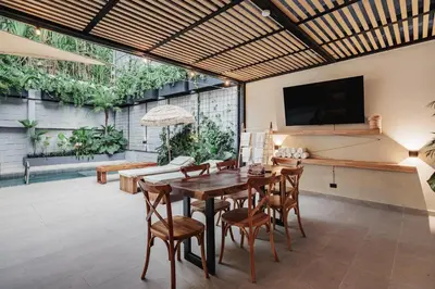 a living room with a wooden table and chairs at 10A House Pool Provenza in Medellín
