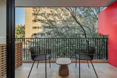a balcony with three chairs and a table and a window at Exquisito Estudio en Provenza in Medellín