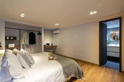 a bedroom with a large white bed and a window at Surprising, Lleras Park, Billar Pool And Jacuzzi in Medellín