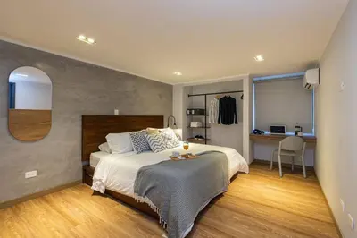 a bedroom with a bed and a desk in a room at Surprising, Lleras Park, Billar Pool And Jacuzzi in Medellín