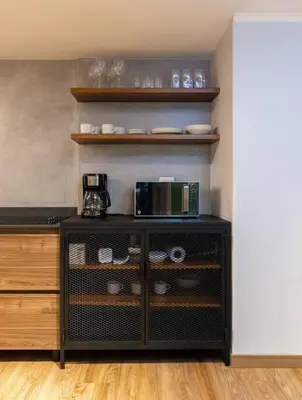 a kitchen with a black cabinet with a microwave at Surprising, Lleras Park, Billar Pool And Jacuzzi in Medellín