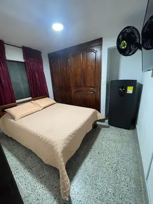 a bedroom with a bed and a wooden door at El Descanso in Rionegro