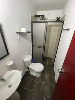 a bathroom with a toilet and a sink and a shower at El Descanso in Rionegro