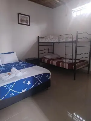 a bedroom with two bunk beds in a room at Hotel campestre París soleil in Mariquita
