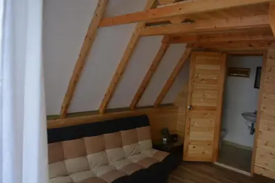a living room with a couch in the attic at Cabaña Madre Selva in San Vicente