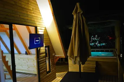 a bathroom with a umbrella next to a tub at Cabaña Madre Selva in San Vicente