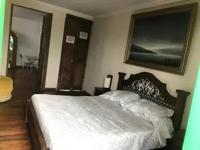 a bedroom with a bed and a picture on the wall at Hotel Colonial - Salamina Caldas in Salamina