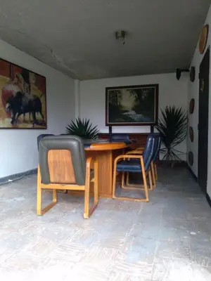 a dining room with a wooden table and chairs at Hotel Colonial - Salamina Caldas in Salamina