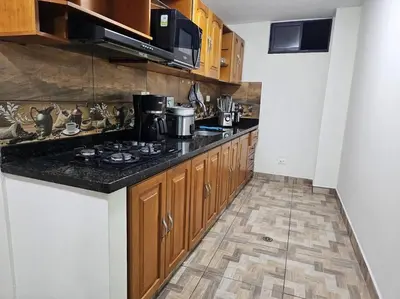 a kitchen with a stove and a counter top at Espacioso y lindo lugar in Bello