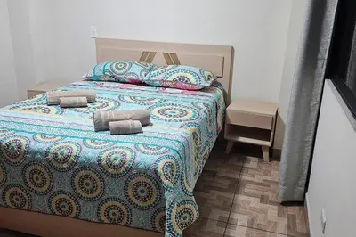 a bed with two pillows on it in a bedroom at Espacioso y lindo lugar in Bello