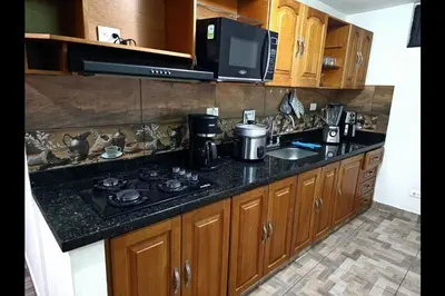 a kitchen with a stove and a counter top at Espacioso y lindo lugar in Bello
