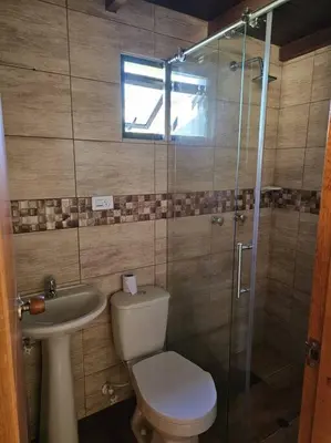 a bathroom with a shower and a toilet and a sink at Espacioso y lindo lugar in Bello