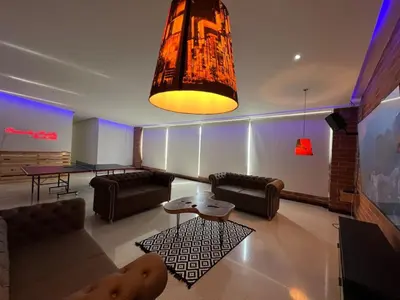 a large living room with couches and a table at Poblado Villa Great views Nature Jacuzzi Security in Medellín