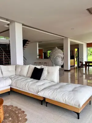a white couch in a living room with a statue at Poblado Villa Great views Nature Jacuzzi Security in Medellín