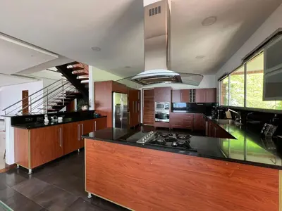 a kitchen with a counter top and a stove at Poblado Villa Great views Nature Jacuzzi Security in Medellín