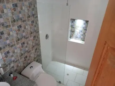 a bathroom with a toilet and a shower at Casa Finca Hotel Loma Encantada in Guatapé